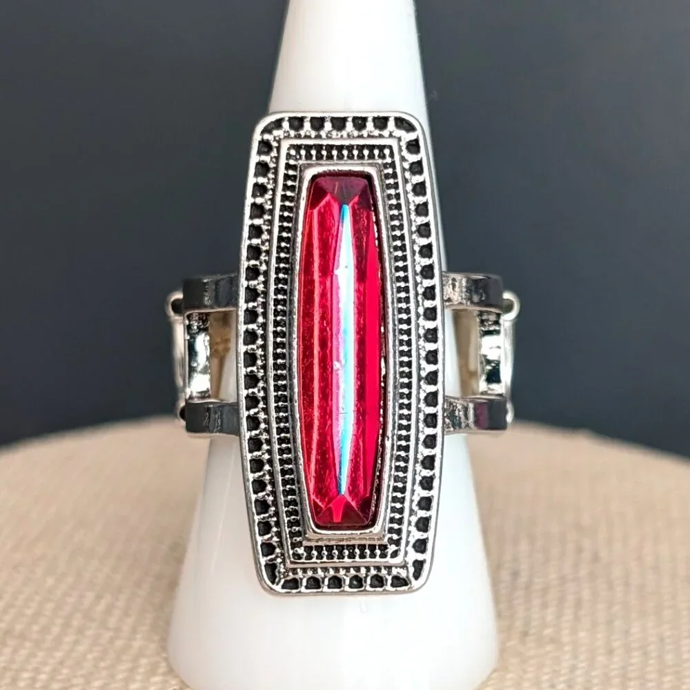 Orangey red glass ring with center bright blue stripe stretch ring